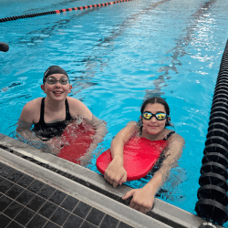 Happy children playing a game at a table and smiling at camera